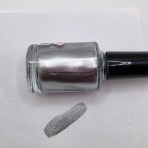 Silver nail polish with swatch on paper.