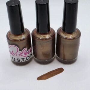 Three bottles of brown nail polish.