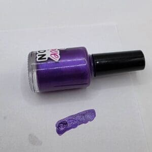 Purple nail polish with a swatch.
