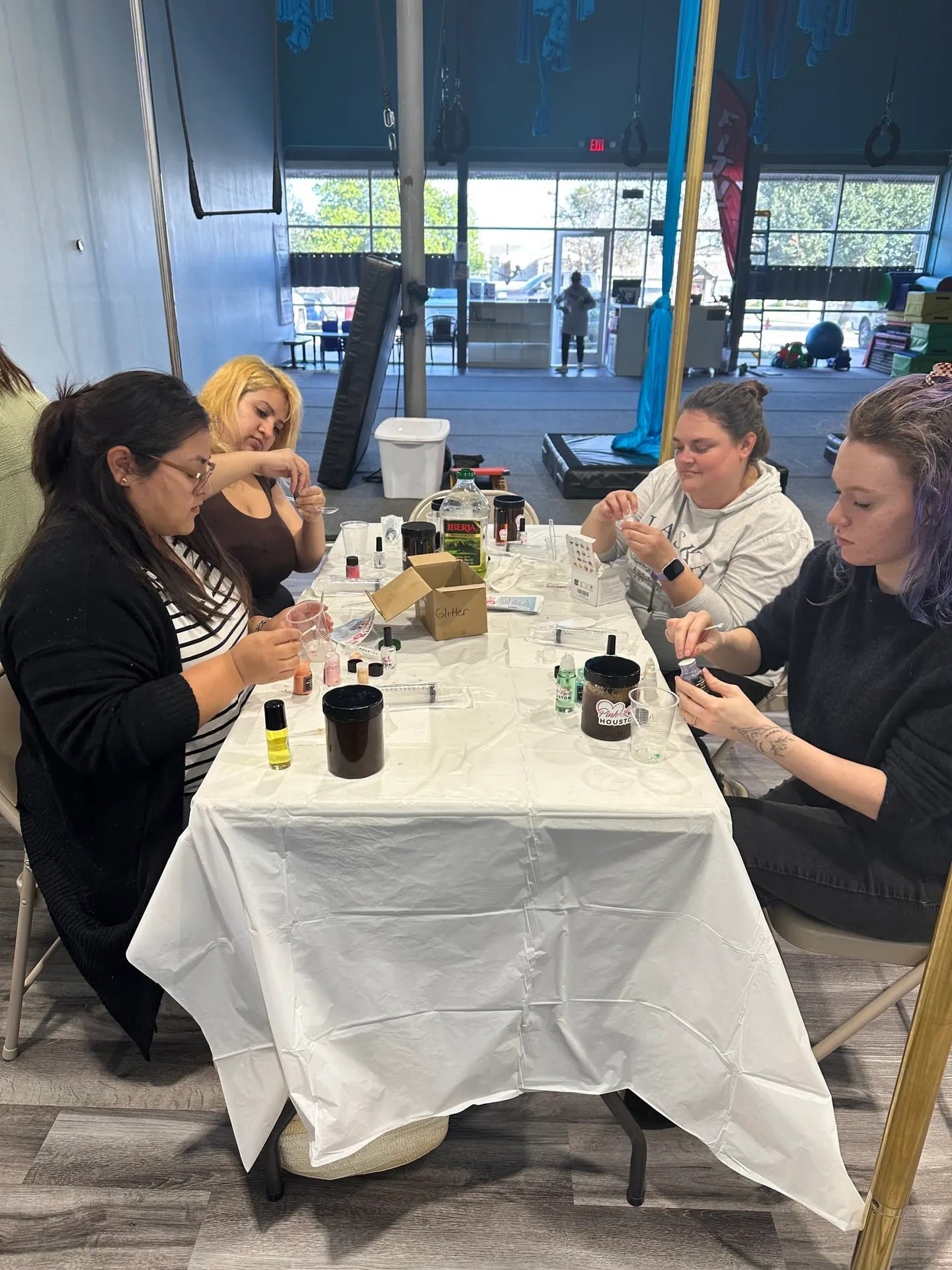 People crafting at a table together indoors.