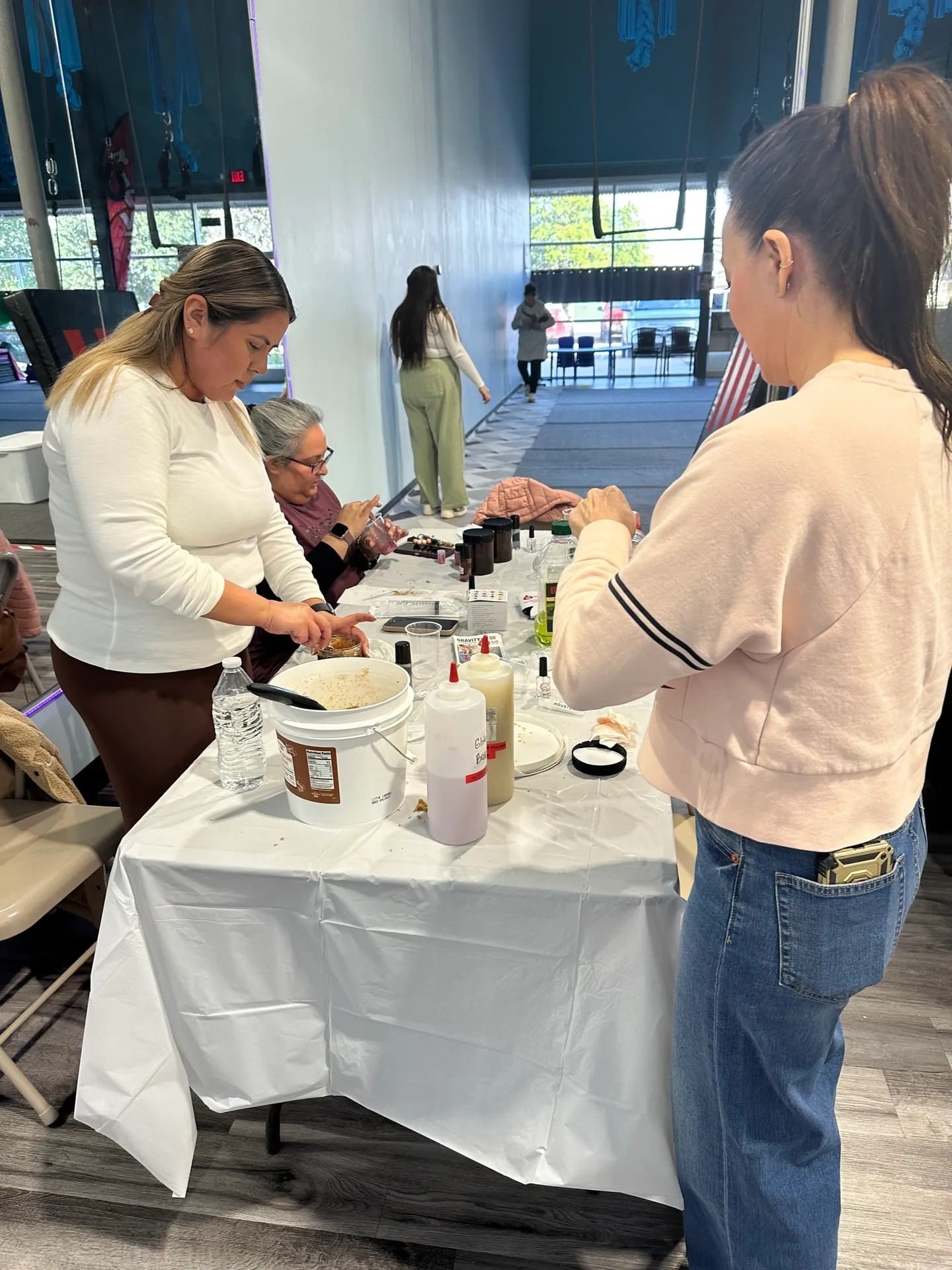 People preparing food at a table event.