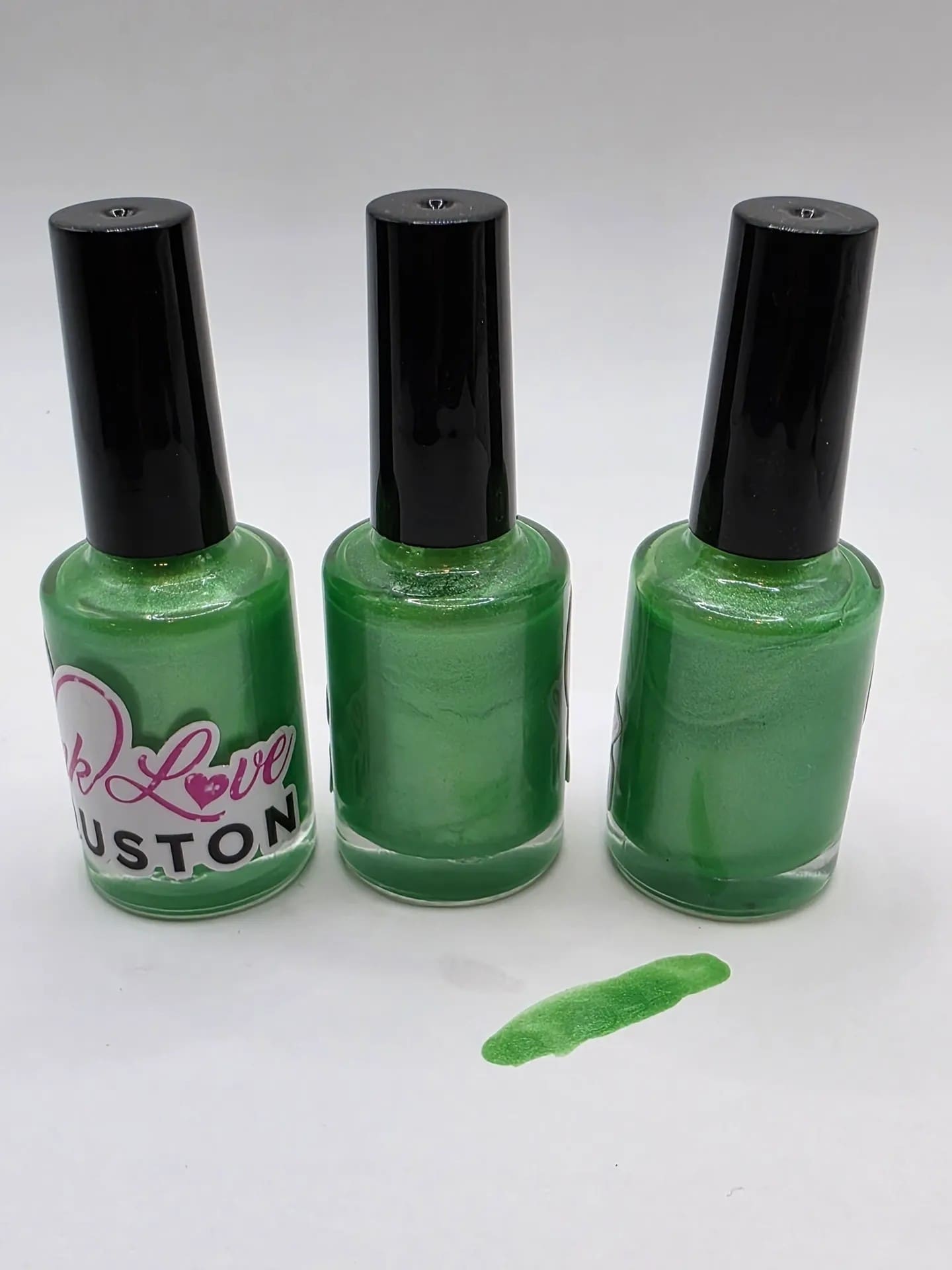 Three bottles of green nail polish.