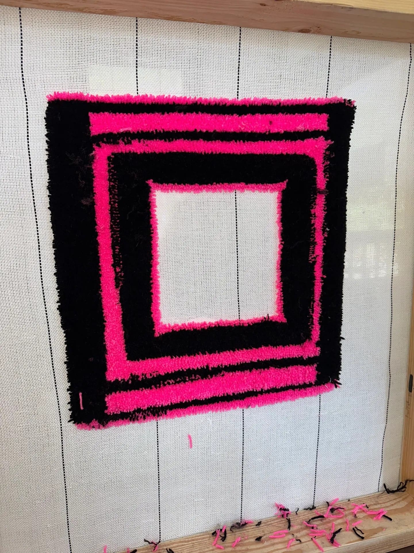 Pink and black geometric tufted pattern.